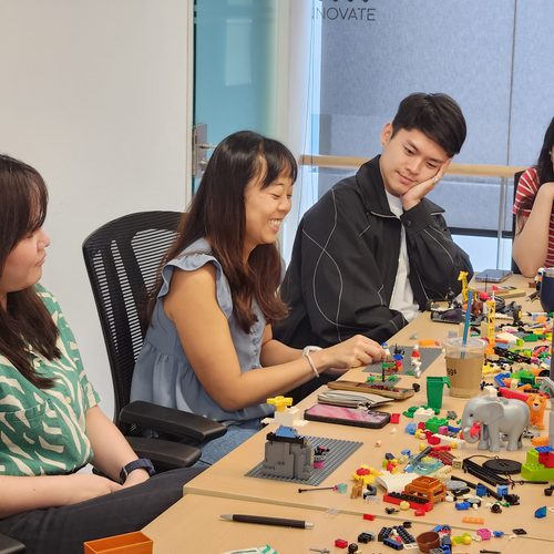 Colleagues building with LEGO SERIOUS PLAY at their desks